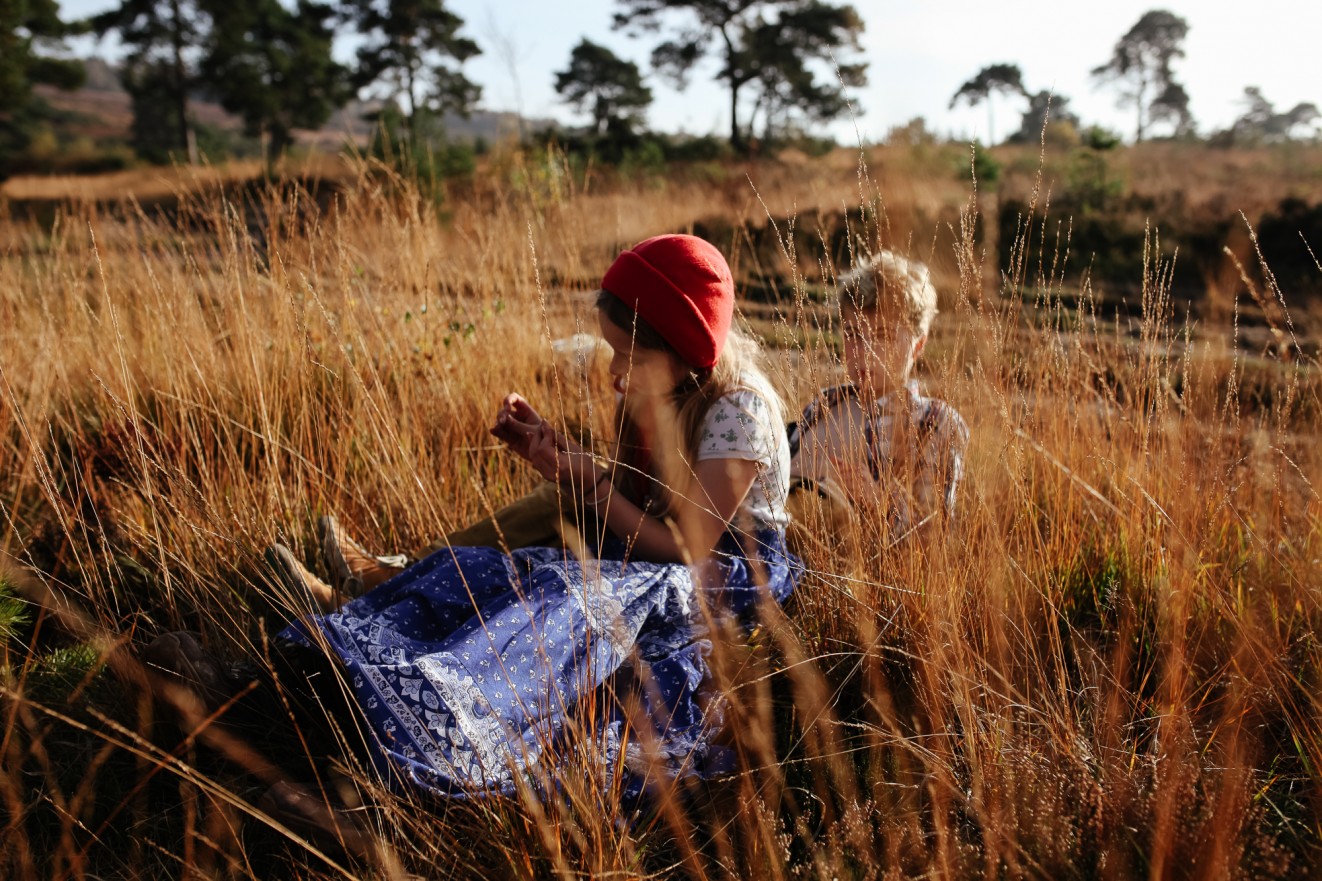 Bonnets for winter in long grass; Childrens portrait photographer in London, Surrey and Kent London Children Photography 