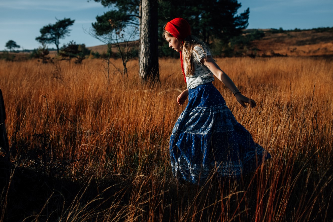 Bonnets for winter in long grass; Childrens portrait photographer in London, Surrey and Kent London Children Photography 