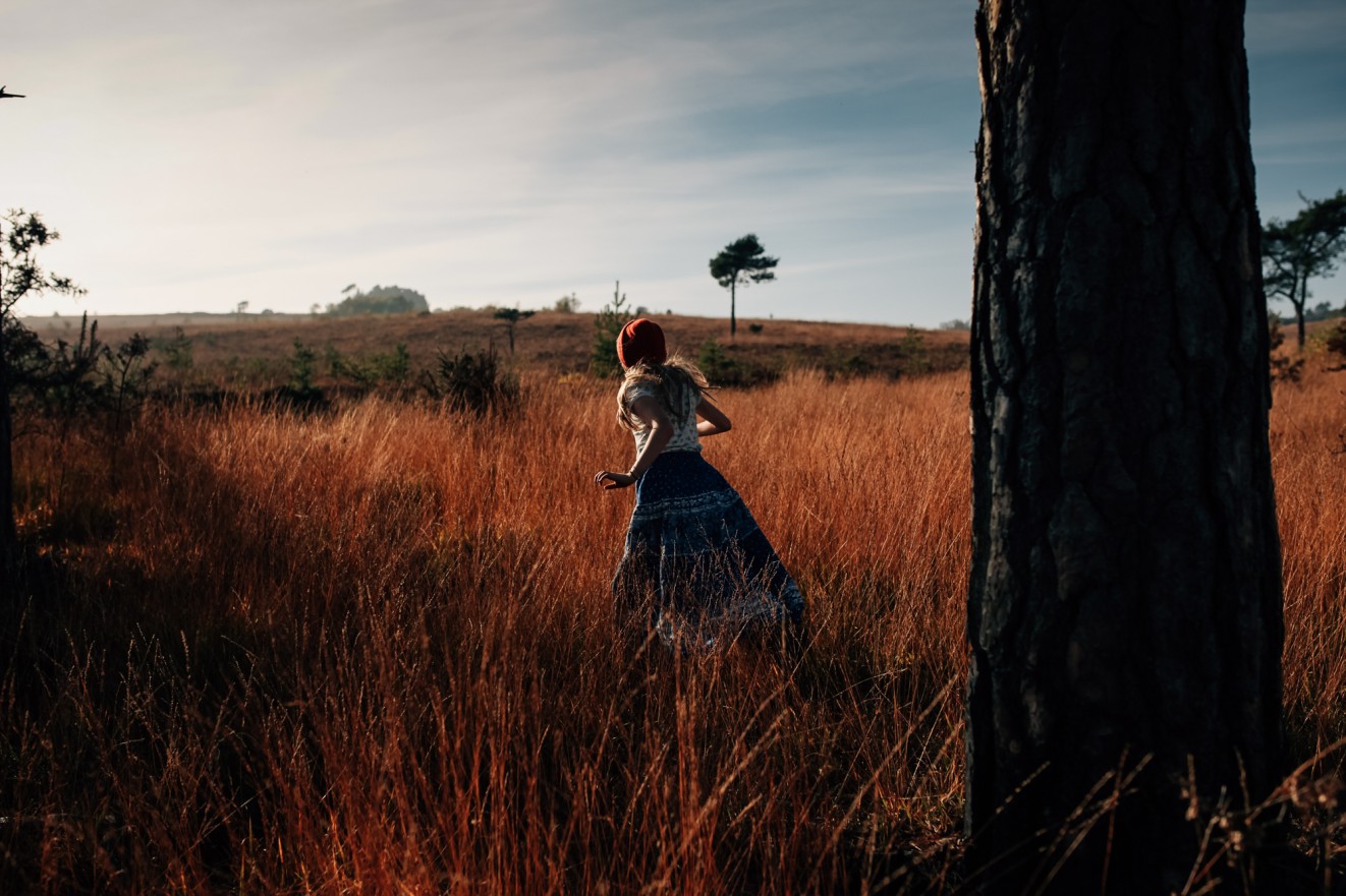 Bonnets for winter in long grass; Childrens portrait photographer in London, Surrey and Kent London Children Photography 