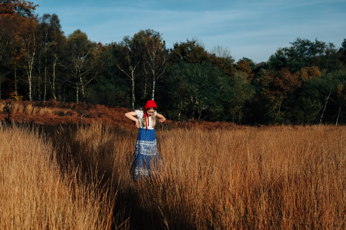 Bonnets for winter in long grass; Childrens portrait photographer in London, Surrey and Kent London Children Photography 