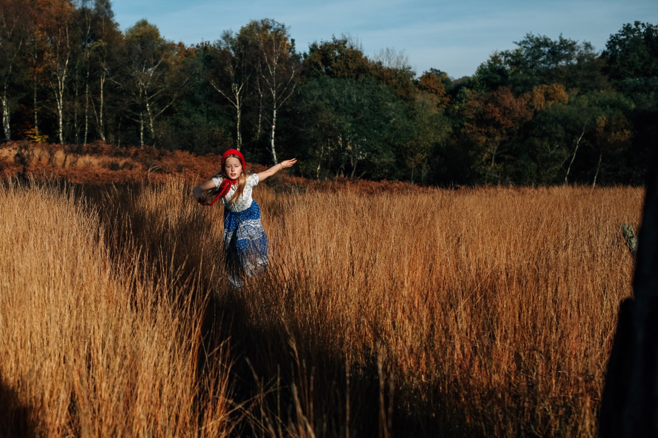 Bonnets for winter in long grass; Childrens portrait photographer in London, Surrey and Kent London Children Photography 